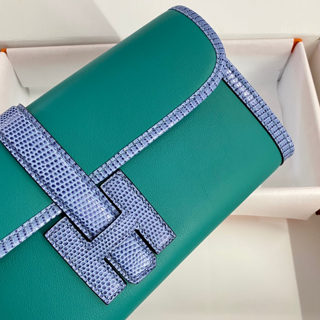 JIGE ELAN 29 CLUTCH IN TEAL GREEN CALFSKIN WITH ROYAL BLUE LIZARD SKIN