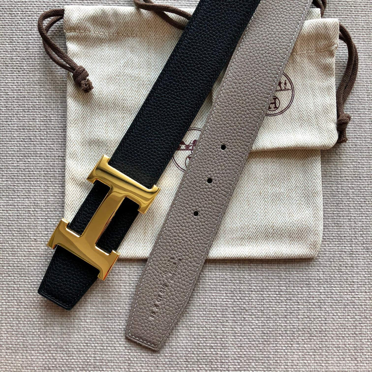 HM BELT BUCKLE & REVERSIBLE BLACK AND TAN BROWN LEATHER STRAP 38MM GOLD HARDWARE