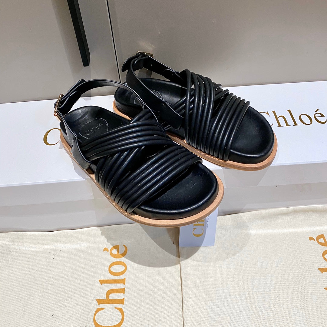 CROSS STRAP SANDAL IN BLACK RUBBER WITH GOLD HARDWARE