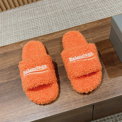 FURRY SLIDES IN ORANGE CURLY SHEARLING