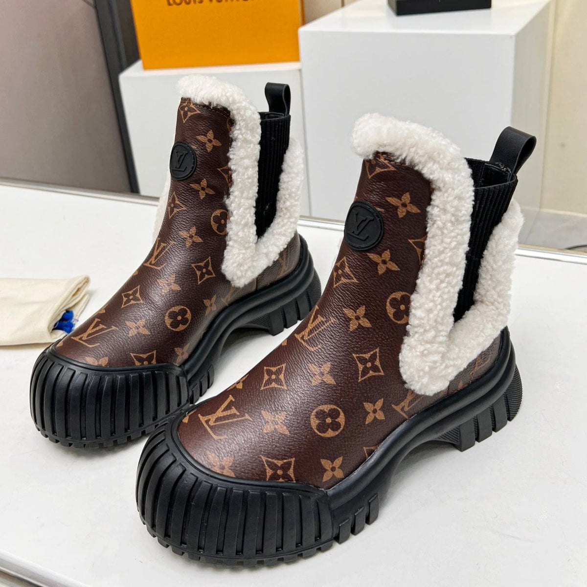 LV RUBY FLAT ANKLE BOOT IN CHOCOLATE BROWN MONOGRAM CALFSKIN AND WHITE SHEARLING