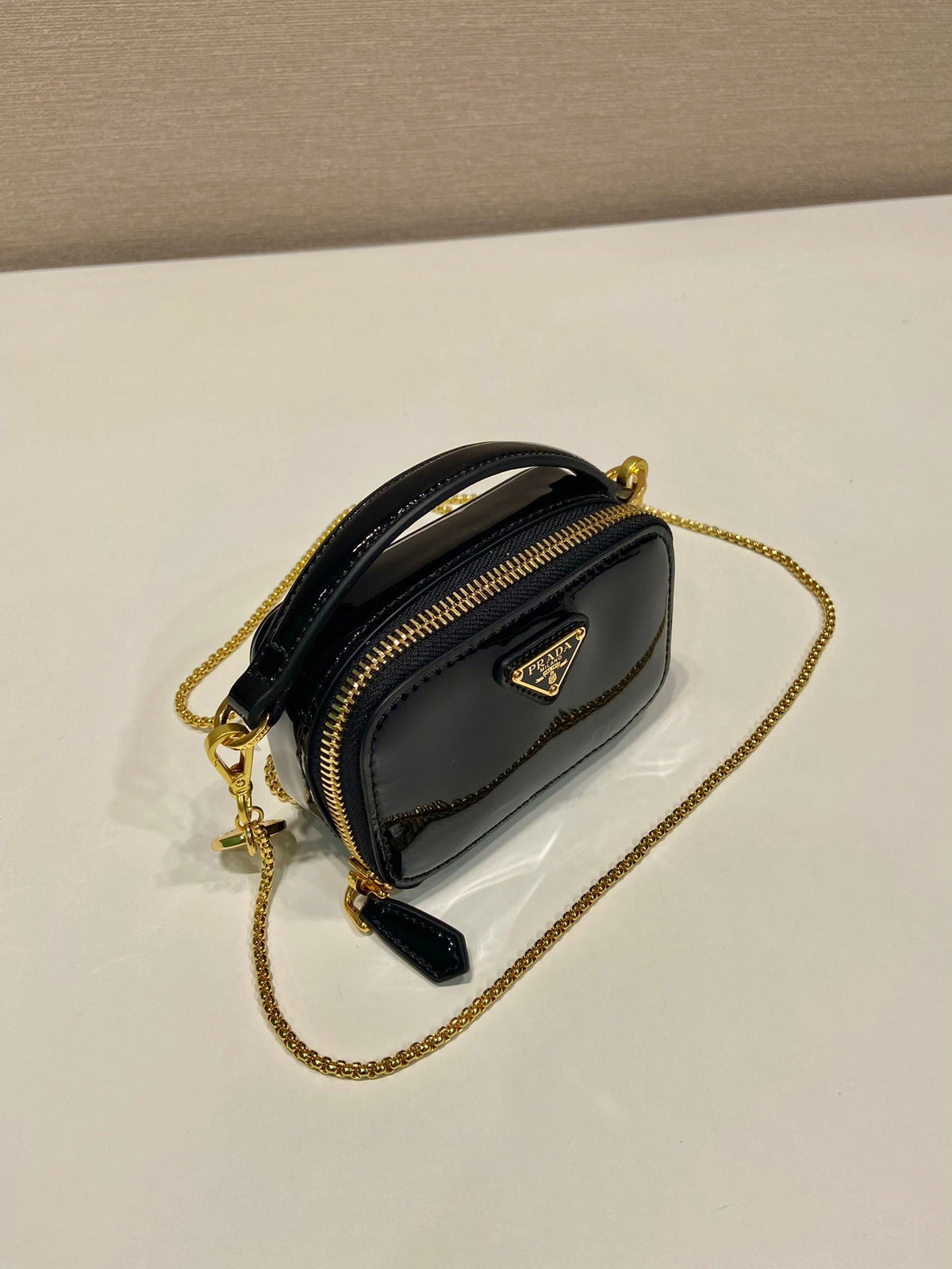 MINI HAND BAG 11 WITH GOLD STRAP IN BLACK PATENT CALFSKIN