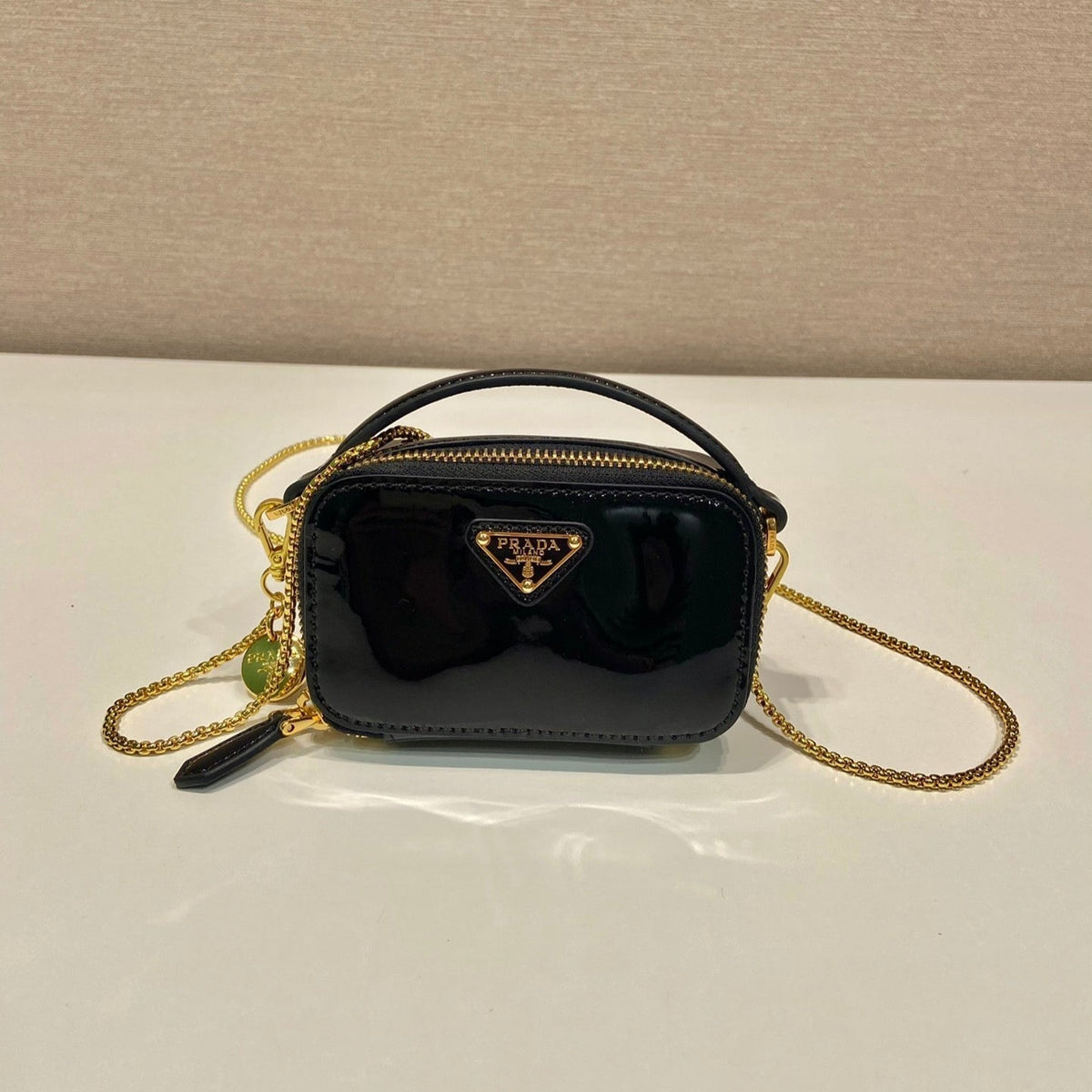MINI HAND BAG 11 WITH GOLD STRAP IN BLACK PATENT CALFSKIN