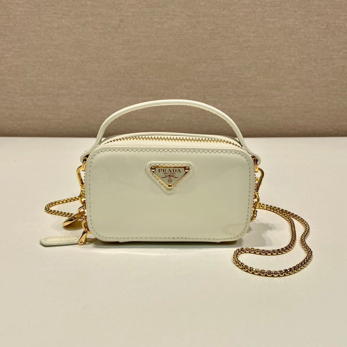 MINI HAND BAG 11 WITH GOLD STRAP IN WHITE PATENT CALFSKIN