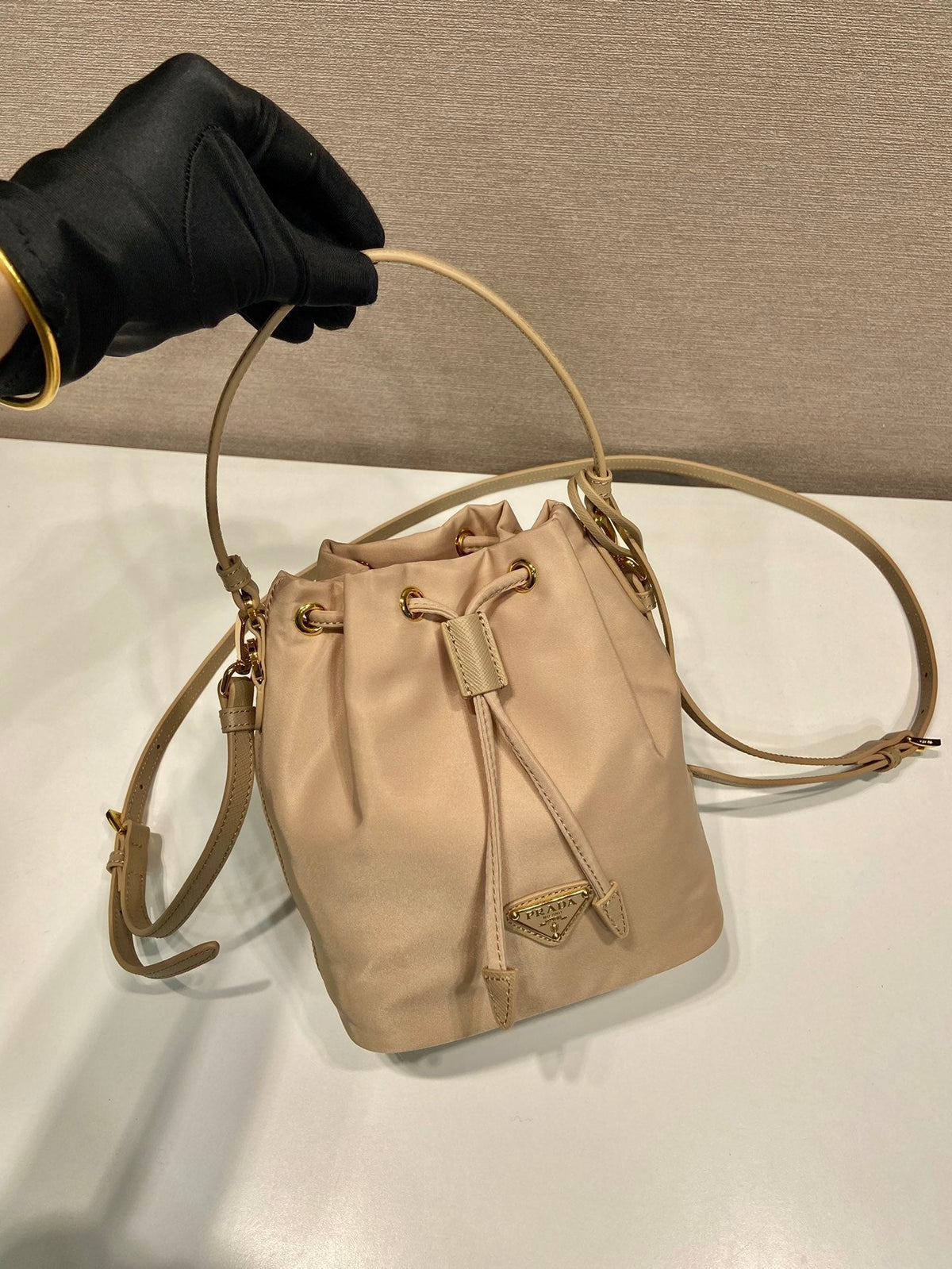 BUCKET BAG 19 IN BEIGE RE-NYLON AND SAFFIANO LEATHER HANDLE
