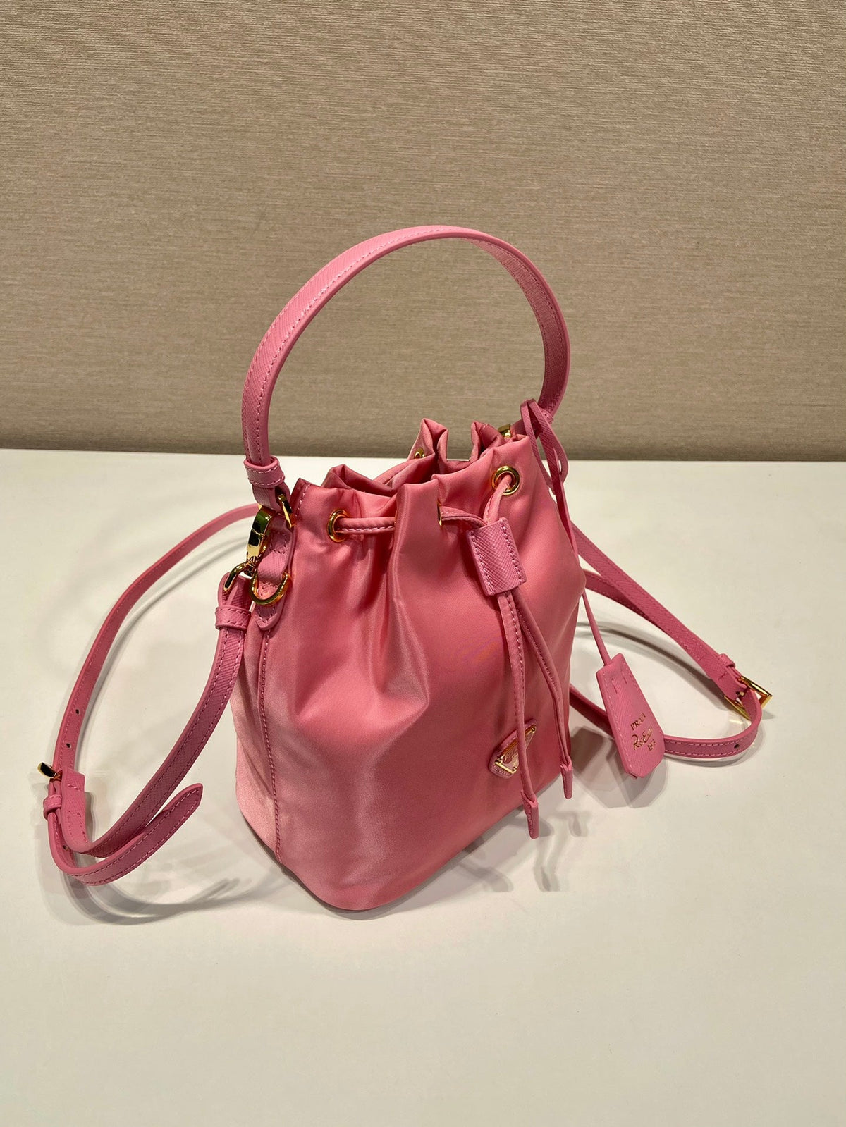 BUCKET BAG 19 IN CANDY PINK RE-NYLON AND SAFFIANO LEATHER HANDLE