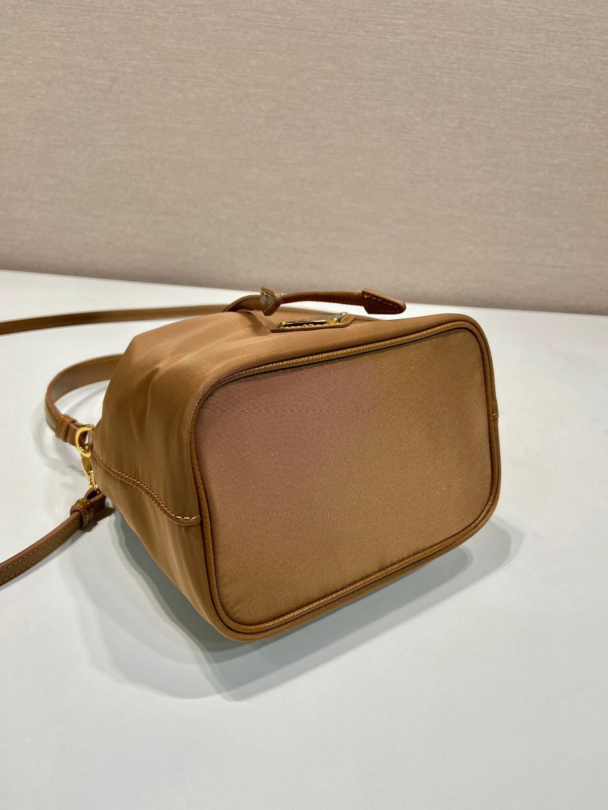 BUCKET BAG 19 IN RUSSET BROWN RE-NYLON AND CALFSKIN HANDLE
