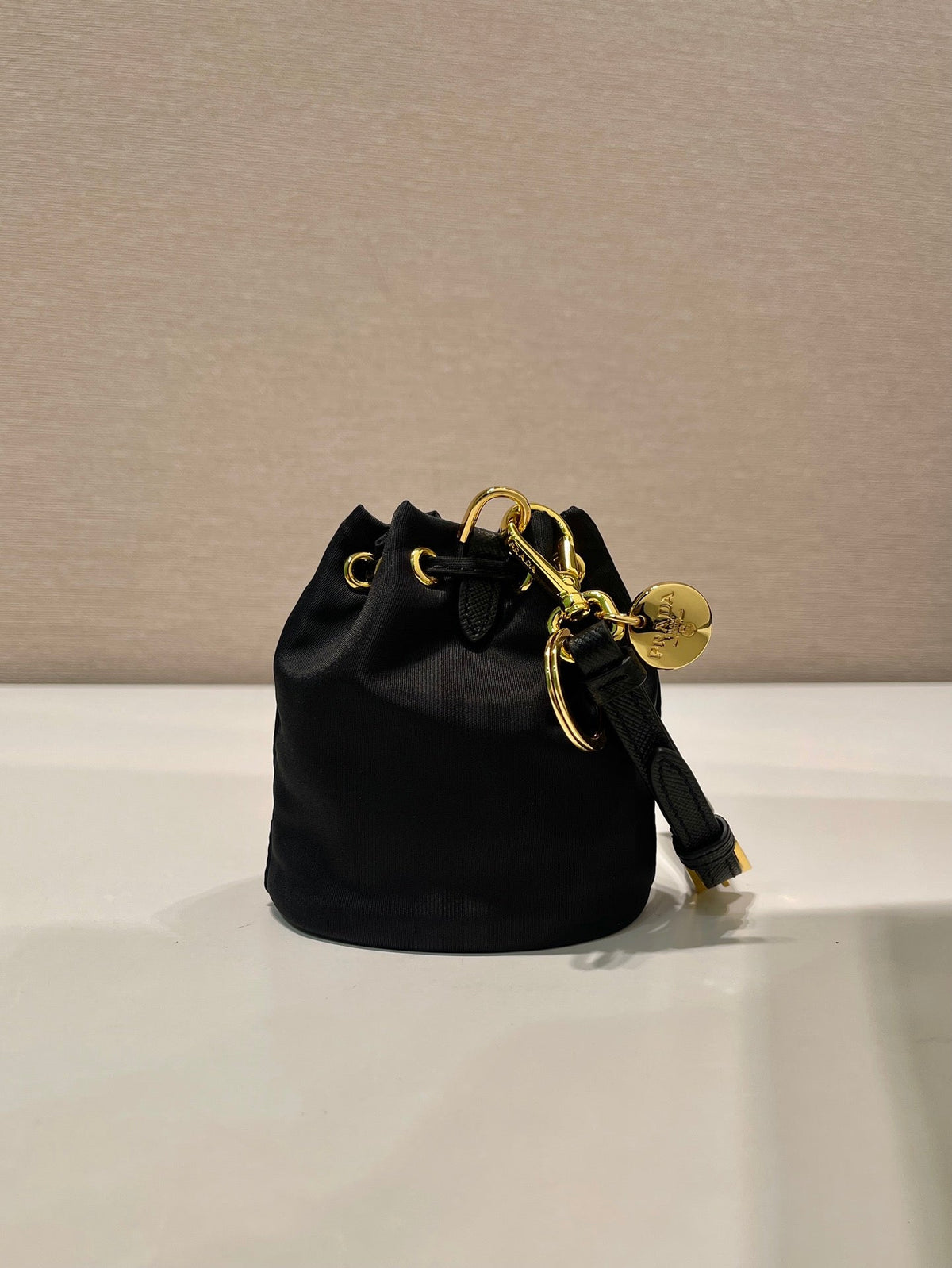 MINI BUCKET BAG 10 IN BLACK RE-NYLON AND SAFFIANO LEATHER STRAP