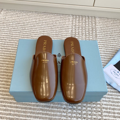 MULES IN BROWN GLOSSY SHEEPSKIN GOLD LETTERING LOGO