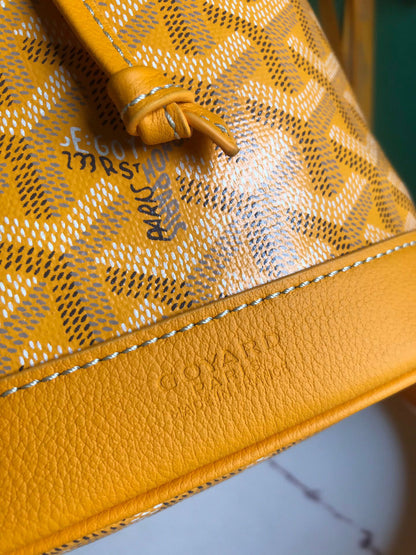 PETIT FLOT BUCKET BAG 22 IN YELLOW GOYARDINE CANVAS AND LAMBSKIN TRIM