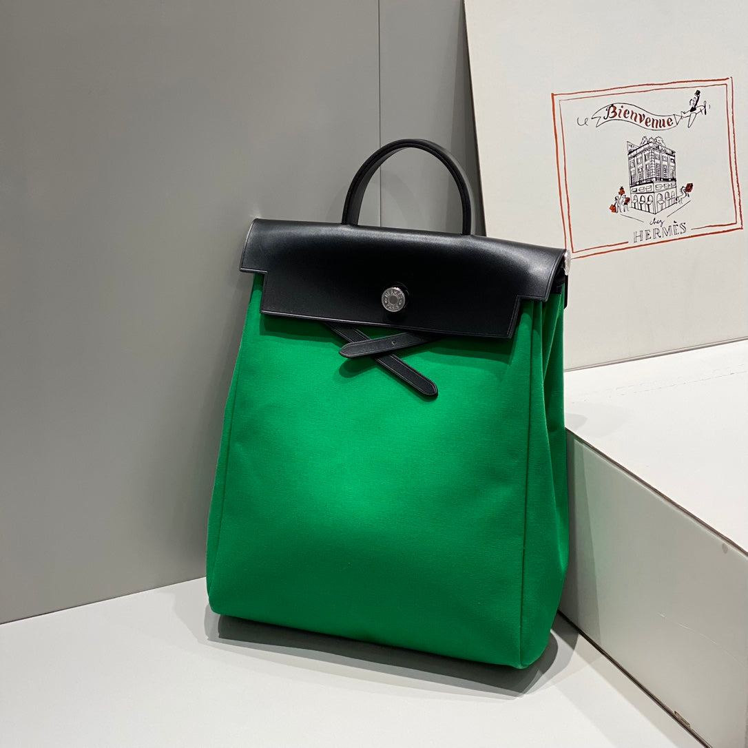 HERBAG A DOS ZIP RETOURNE BACKPACK 29 IN GREEN CANVAS AND BLACK CALFSKIN