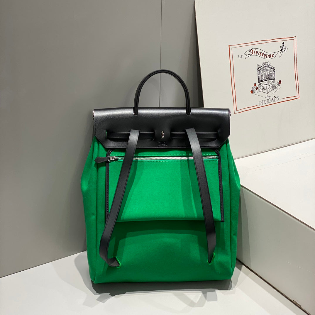 HERBAG A DOS ZIP RETOURNE BACKPACK 29 IN GREEN CANVAS AND BLACK CALFSKIN
