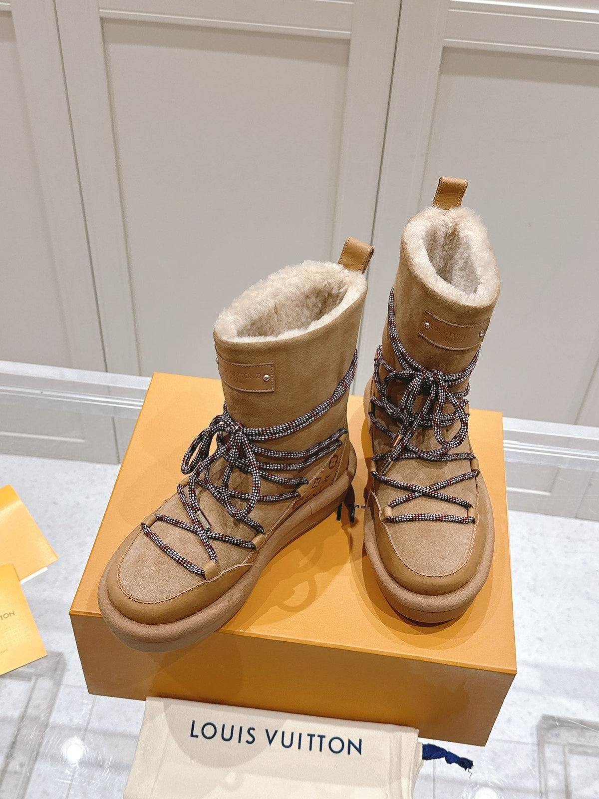 ASPEN PLATFORM ANKLE BOOT IN CIDER BROWN MONOGRAM DEBOSSED SUEDE AND SHEARLING