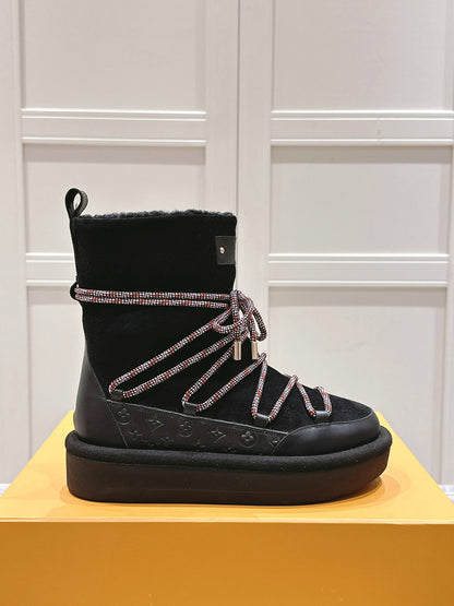 ASPEN PLATFORM ANKLE BOOT IN BLACK MONOGRAM DEBOSSED SUEDE AND SHEARLING