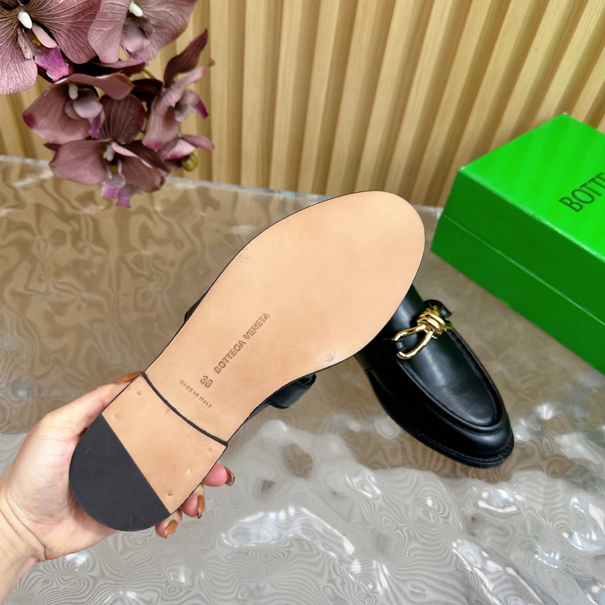 OPEN-BACK LOAFER REALISED IN BLACK SOFT CALFSKIN WITH SIGNATURE METALLIC KNOT DETAIL
