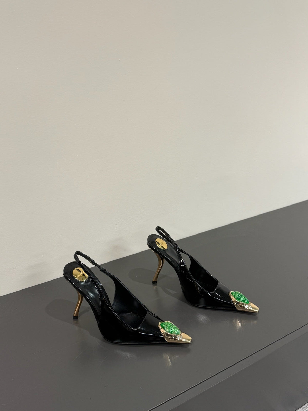 GREEN GEM-STUDDED SLINGBACK PUMPS IN BLACK PATENT CALFSKIN