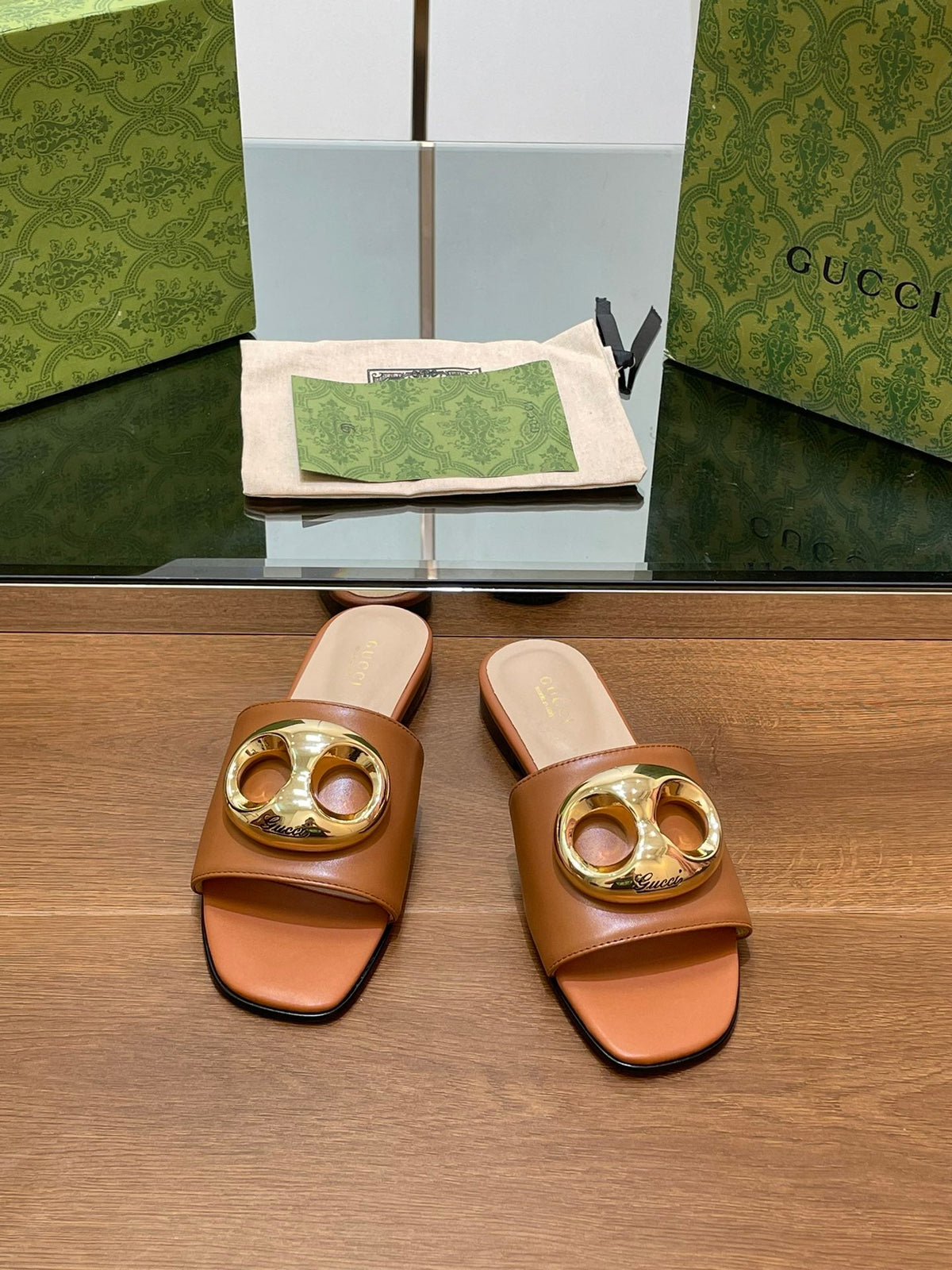 FLAT MULE IN BRONE BROWN CALFSKIN WITH GOLD HARDWARE