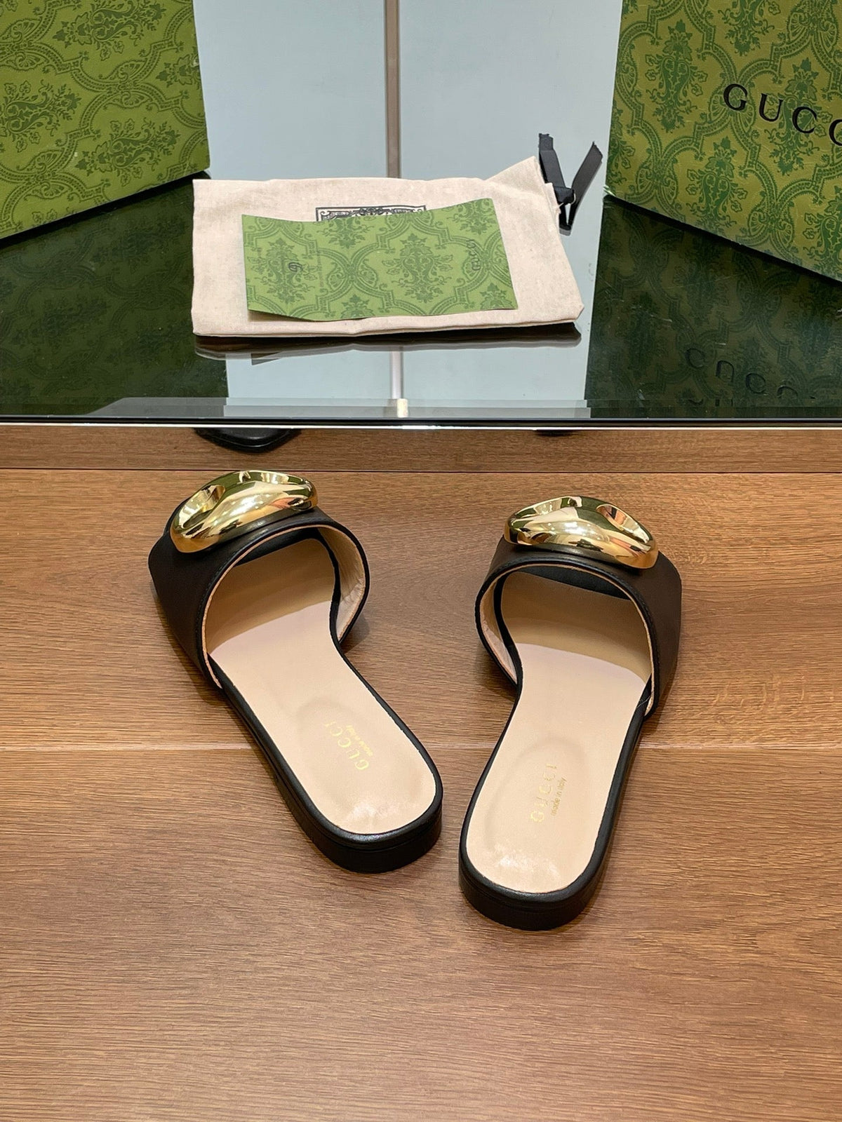 FLAT MULE IN BLACK CALFSKIN WITH GOLD HARDWARE