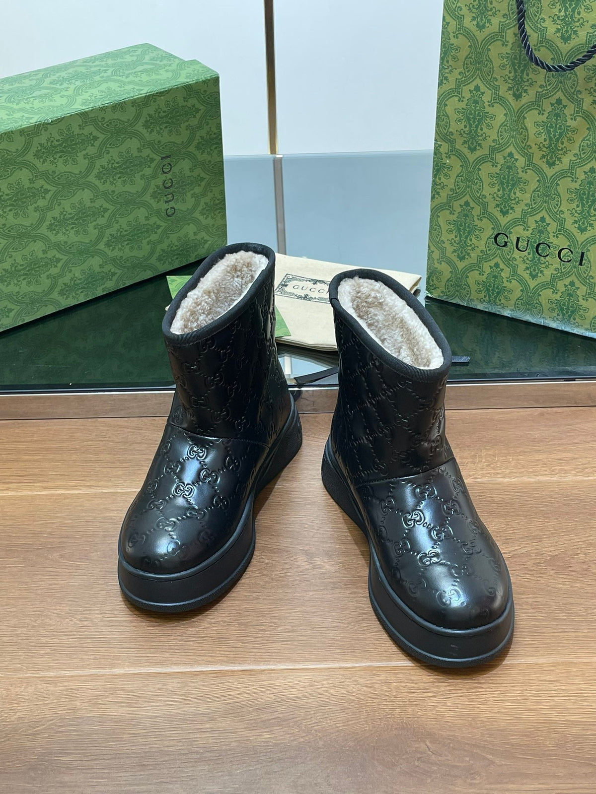 GG UGG BOOTS IN BLACK EMBOSSED DEERSKIN AND BEIGE WOOL LINING