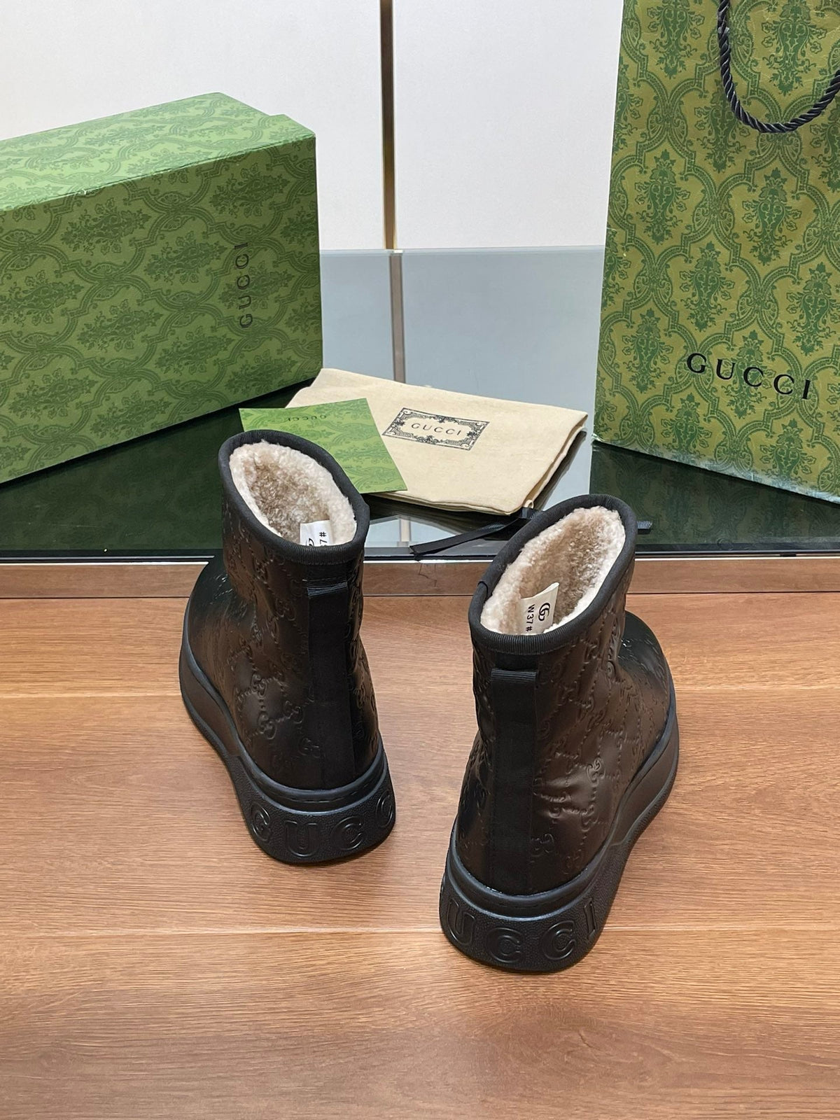 GG UGG BOOTS IN BLACK EMBOSSED DEERSKIN AND BEIGE WOOL LINING