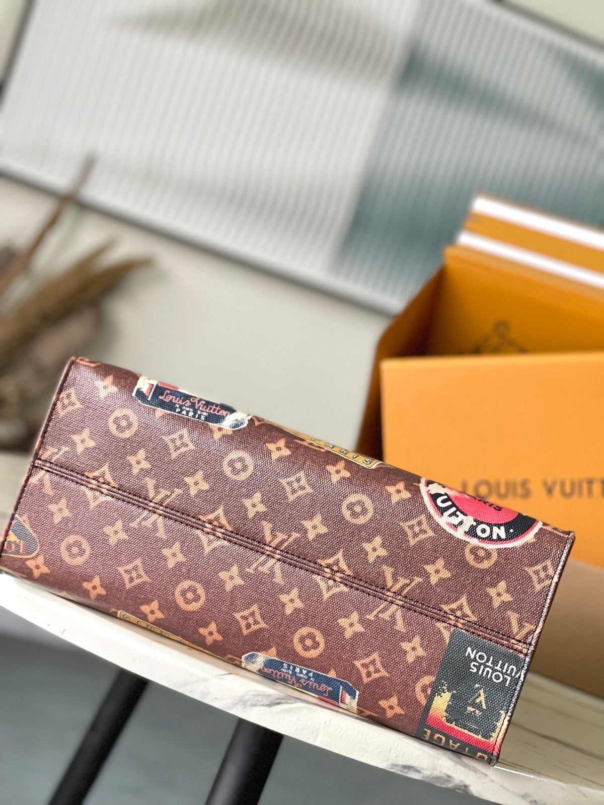 ONTHEGO VOYAGE 35 IN BROWN MONOGRAM CANVAS WITH VINTAGE HOTEL LABELS