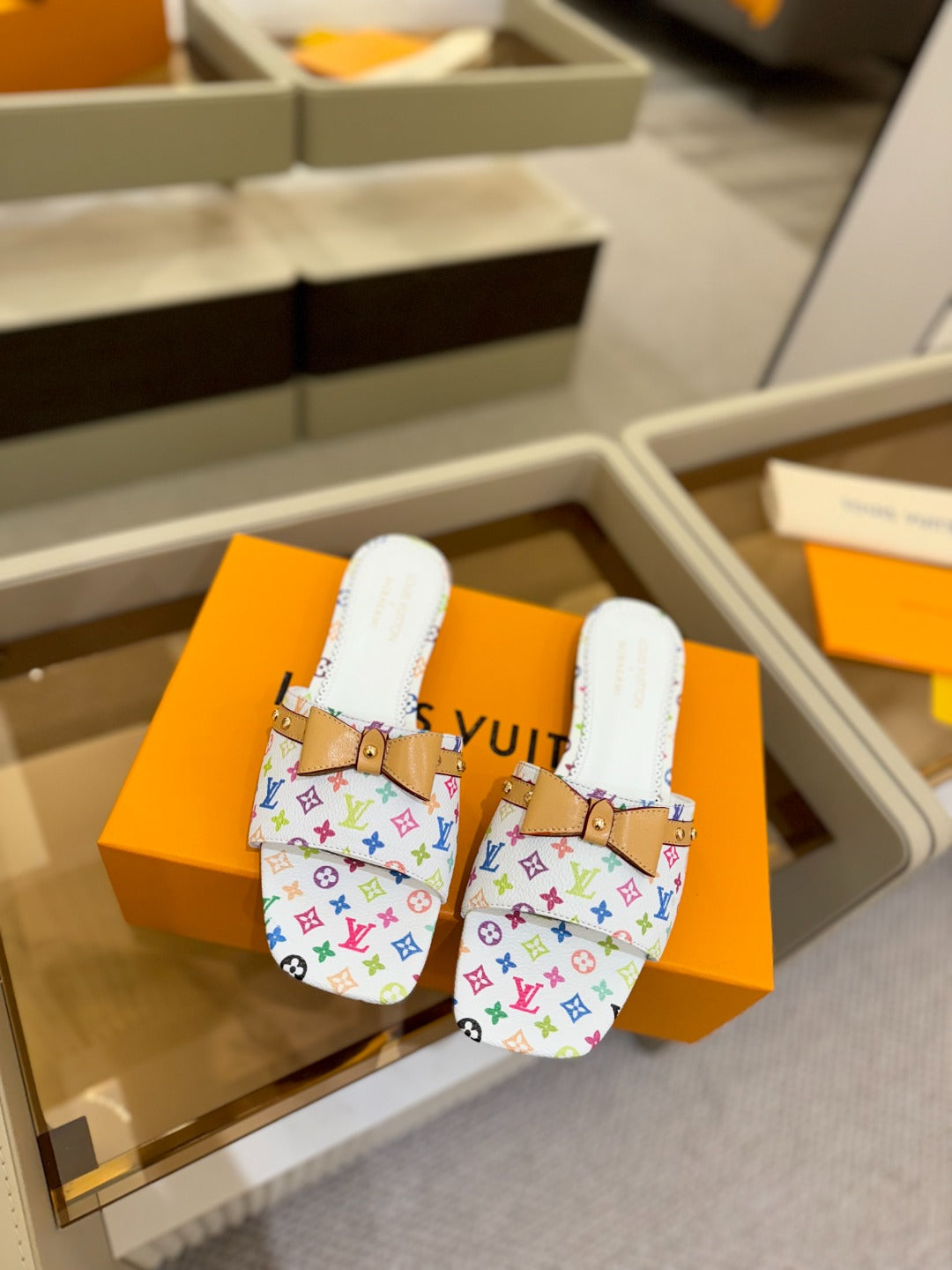 LV X TM 6AM FLAT MULE IN WHITE MONOGRAM CALFSKIN