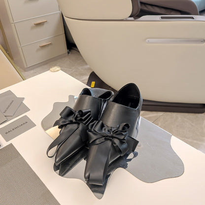POINTED-TOE FLATS WITH BOW IN BLACK SOFT LAMBSKIN