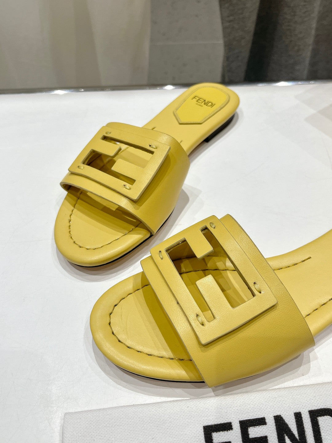 FENDI BAGUETTE SLIDES IN BRIGHT YELLOW LAMBSKIN