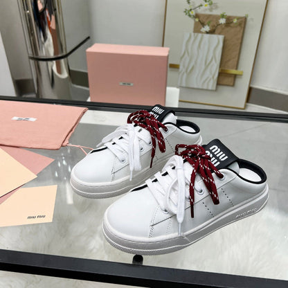 SNEAKER MULES IN BLACK AND WHITE CALFSKIN WHITE RED LACES