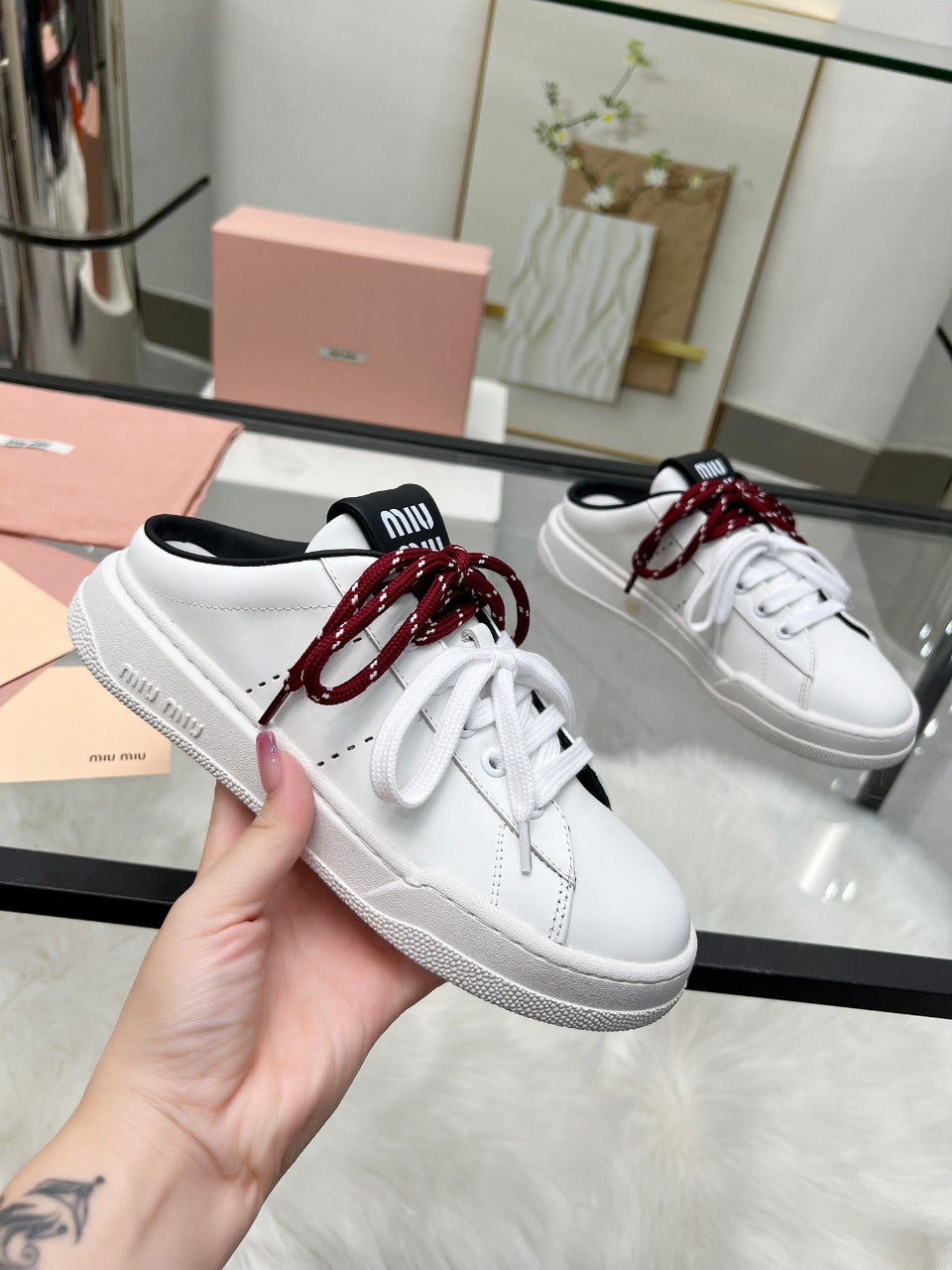 SNEAKER MULES IN BLACK AND WHITE CALFSKIN WHITE RED LACES