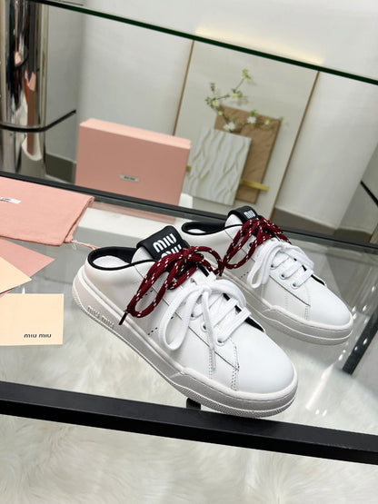 SNEAKER MULES IN BLACK AND WHITE CALFSKIN WHITE RED LACES